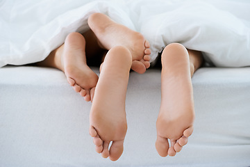 Image showing Couple, morning or feet with blanket in sleeping for peace or rest together on weekend in a house. Wellness, comfort or closeup of barefoot people in home for bond, care or nap under duvet in bedroom