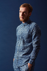 Image showing Man, fashion and chic clothes in studio with unique style, denim and trendy on blue background. Irish odel with hipster beard, red hair with serious face and stylish, fashionable shirt and jeans