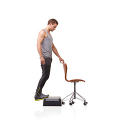 Image showing Fitness, chair and young man in studio for health, wellness and body workout with step. Sports, equipment and male athlete training muscles with leg exercise for strength isolated by white background
