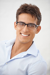 Image showing Man, face and glasses for vision with eye care, happy with optometry and professional style on white background. Smile in portrait for eyesight with fashion frame and prescription lens in studio