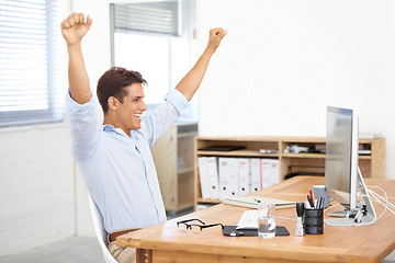 Image showing Happy businessman, fist pump and celebration for winning, success or bonus promotion at office. Excited man or employee smile by desk or table for prize, deal or good news on computer at workplace