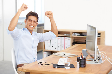 Image showing Excited businessman, portrait and fist pump in celebration for winning, success or bonus promotion at office. Happy man or employee smile by desk for prize, deal or good news on computer at workplace