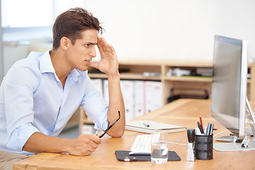 Image showing Frustrated businessman, headache and stress on computer in mistake, burnout or fatigue at the office. Man or employee with migraine in anxiety, mental health or work pressure by PC desk at workplace