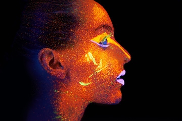 Image showing Art, woman and profile with neon paint on face and beauty, bright lipstick and creative skincare on dark background. Orange glow, disco aesthetic and model in studio for creativity with makeup