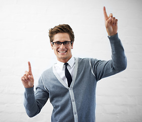 Image showing Man, happiness and pointing with hand, worker and professional in corporate clothes, fashion or fingers. Working, young and person with gesture, career or geek with glasses, nerd or businessman