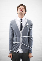 Image showing Man, electrician and tied with cord, boss and portrait for employee, work, angry or job. Frustrated, employer and furious on white background, problem or failure with bad news, stress or risk
