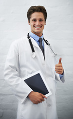 Image showing Happy man, portrait and doctor with thumbs up and tablet for success in healthcare on a white studio background. Male person, surgeon or medical professional smile with like emoji, yes sign or OK