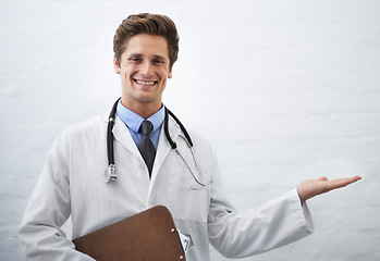 Image showing Happy man, portrait and doctor palm for advertising or marketing in healthcare on a white studio background. Male person, nurse or medical surgeon smile with hand out for presentation on mockup space