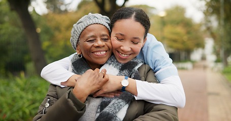 Image showing Caregiver, hug and park with old woman in a wheelchair for retirement, elderly care and physical therapy. Trust, medical and healthcare with portrait of patient and nurse in nature for rehabilitation