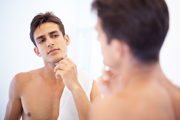 Image showing Man, grooming and towel after washing face in mirror, cleaning and skincare or beauty. Male person, bathroom and wellness in morning routine, reflection and hygiene or self care and shaving at home