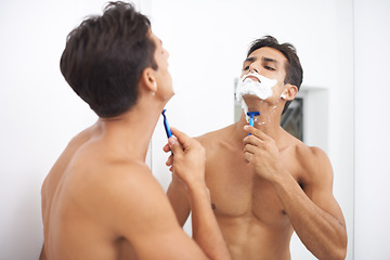 Image showing Man, shaving cream and razor in mirror for hair removal in bathroom, beauty and wellness. Male person, skincare and cosmetics or foam for cleaning in morning routine, grooming and reflection at home