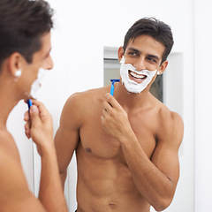 Image showing Man, grooming and razor in mirror for hair removal in bathroom, beauty and wellness. Happy male person, skincare and cosmetics or cleaning in morning routine, shaving cream and reflection at home