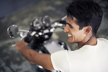 Image showing Happy man, motorcycle and vehicle in garage for travel, transportation or road trip adventure. Young handsome male person or biker smile for cool automobile or ownership of mechanical motorbike