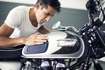 Image showing Handsome man, motorcycle and looking at bike in garage for transportation or vehicle inspection. Young male person or biker admiring motor, engine or cool mechanical power on motorbike in parking lot