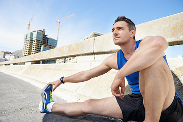 Image showing Man, stretching legs and runner in city, warm up for cardio workout and fitness outdoor. Athlete, sports and running in New York with health, wellness and ready for race or marathon on urban bridge