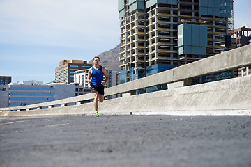 Image showing Man is running on bridge, fitness and cardio outdoor for health and training for marathon. Exercise in city, runner with speed and energy, sports and athlete on urban street for race and endurance