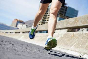 Image showing Legs, running on bridge with fitness and cardio outdoor for health and training for marathon. Exercise in city, runner person in sneakers with speed and energy, sports and athlete on urban street