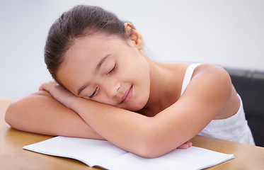 Image showing Child, sleeping or tired student in classroom with burnout, dream or low energy for homework. Happy girl, school or exhausted female kid bored by books with fatigue, education or adhd in a lazy nap