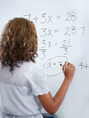 Image showing Woman, teacher and writing on whiteboard for mathematics, numbers or equations in classroom. Rear view of female person, educator or lecturer with sum on board for learning or problem solving class