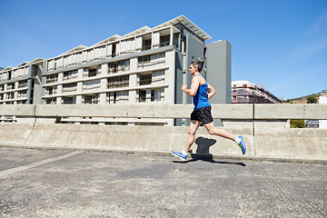 Image showing Man is running on bridge, exercise and cardio outdoor for health and training for marathon. Fitness in city, runner with speed and energy, sports and athlete on urban street for race and endurance