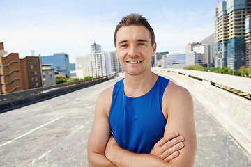 Image showing Happy man, arms crossed in city and fitness outdoor for workout, training and athlete smile in portrait for sports. Confidence, face and exercise on urban bridge, health and wellness in Chicago