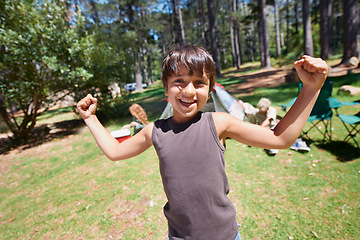 Image showing Boy child, flexing outdoor in portrait and fun at summer camp, happiness and celebration with smile. Kid in nature, adventure with winner or champion, playful youth camper in forest and freedom