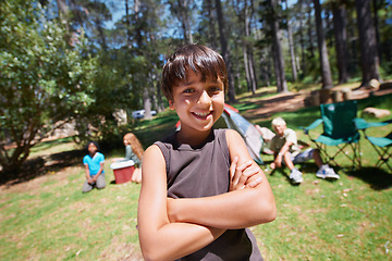 Image showing Boy, kid and arms crossed in portrait summer camp and nature with fun outdoor for youth. Child at campsite in forest, adventure and vacation, childhood and recreation with happiness and smile