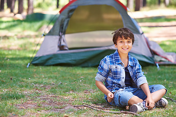 Image showing Tent, camping or portrait of happy child in nature for playing, adventure or holiday vacation in park. Relax, confidence or male child with smile in woods, garden or forest for fun hiking or wellness