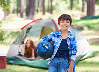 Image showing Sleeping bag, camping or portrait of happy kid in park for adventure or holiday vacation in nature. Relax, start or boy with smile in woods, garden or forest ready for fun hiking, travel or wellness