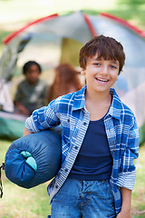 Image showing Sleeping bag, camping or portrait of happy boy in forest on adventure or holiday vacation in nature. Relax, start or kid with smile in park, garden or woods ready for fun hiking, travel or wellness