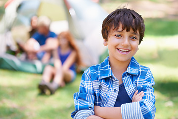 Image showing Boy, child and arms crossed in portrait, summer camp and nature with fun outdoor for youth. Kid at campsite in forest, adventure and vacation, childhood and recreation with happiness and smile