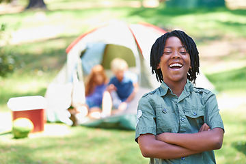 Image showing Boy, kid laughing with arms crossed at summer camp and nature with fun outdoor for youth. African child at campsite in park, adventure and vacation, childhood with recreation and happy in portrait