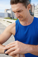 Image showing Man, fitness and checking watch in city for workout, exercise or monitoring outdoor performance. Closeup of male person or athlete looking at wristwatch for training or heart rate in an urban town