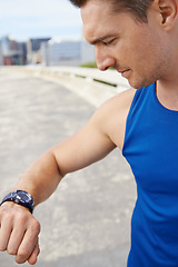 Image showing Man, fitness and looking at watch in city for workout, exercise or monitoring outdoor performance. Closeup of male person or athlete checking wristwatch for training or heart rate in an urban town