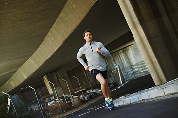 Image showing Man, runner and exercise on road in outdoor, cardio and fitness or training for marathon. Male person, athlete and workout by city background, sportswear and performance challenge by bridge on street