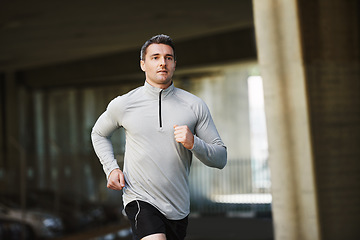 Image showing Man, runner and training on street in outdoor, cardio and exercise or prepare for marathon. Male person, athlete and workout by city background, sportswear and performance challenge by bridge on road