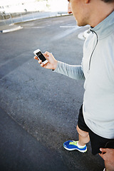 Image showing Man, runner and checking phone for progress, screen and exercise or training for marathon. Male person, athlete and workout by city background, mobile app and performance challenge or timer on road