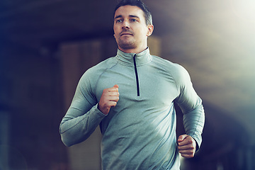 Image showing Man, fitness and running for cardio workout, exercise or training with lens flare at the gym. Active male person, runner or athlete for weight loss, health and wellness in fitness on mockup space