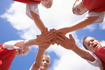 Image showing Hands, huddle and group of children on soccer team, team building and collaboration or support in circle. People, solidarity and team or partnership and trust in community, unity and sky background