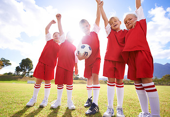 Image showing Children, soccer team and celebration for winning or victory, happy and success in outdoors. People, kids and fist pump for achievement, collaboration and partnership or teamwork on field or sport