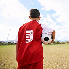 Image showing Child, back view and soccer player on field for training, workout and ready for practice on grass. Boy, athlete and ball for exercising and skill development, fitness and wellness or sports and game