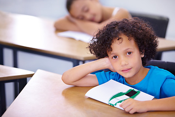 Image showing Portrait, child or student in classroom for knowledge, education or development for future growth. Scholarship, back to school or boy with book or pride for studying, drawing or learning at his desk