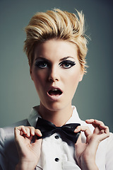 Image showing Portrait, bow tie and model with fashion, vintage clothes and classy aesthetic on grey background. Hands, edgy fashionable woman or cool female person with retro style and makeup isolated in studio