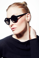 Image showing Woman, sunglasses for beauty or fashion, confidence and wellness with protection from sun on white background. Black eyewear, casual clothes and pose in studio with makeup, eye care and cosmetics