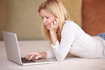 Image showing Woman, remote work from home and laptop on floor, smiling and type email for job, copywriter or creative. Freelancer, technology and working for startup publishing company, internet or online worker