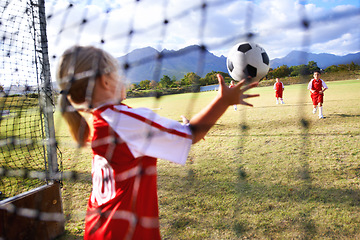 Image showing Girl, soccer and ball with goal keeper for save, match or game from scoring point on outdoor field. Team of football players playing together for sports, competition or training practice in nature