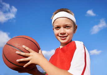 Image showing Happy boy, portrait and basketball for sports game, match or competition with blue sky background. Face of male person, child or player smile with ball for outdoor competition or practice in nature