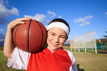 Image showing Happy girl, portrait and basketball on green grass for outdoor match or fun game in nature. Face of young female person, kid or sports player smile with ball on field and cloudy blue sky for exercise