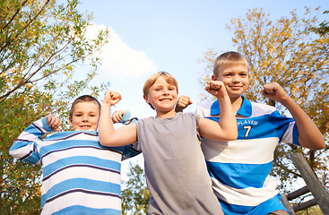 Image showing Happy children, portrait and flexing muscles at park for fun day, holiday or weekend together in nature. Face of young kids or friends smile for outdoor summer break, bonding or youth on playground