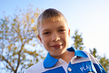 Image showing Happy boy, portrait and playing in park with sunset for fun holiday, weekend or outdoor break in nature. Face of male person, kid or child smile on playground for childhood, activity or day outside